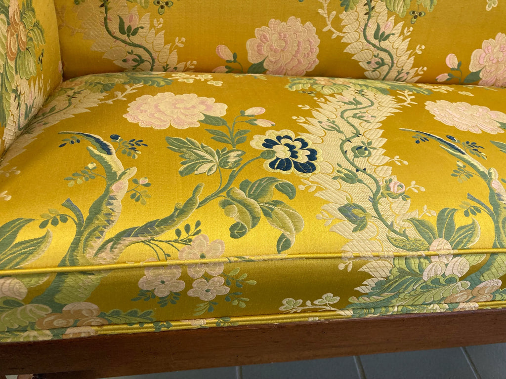Early 20th Century Chippendale Camelback Scroll Arm Settee in Golden and Pink Famille Rose Chinoiserie Silk Brocade