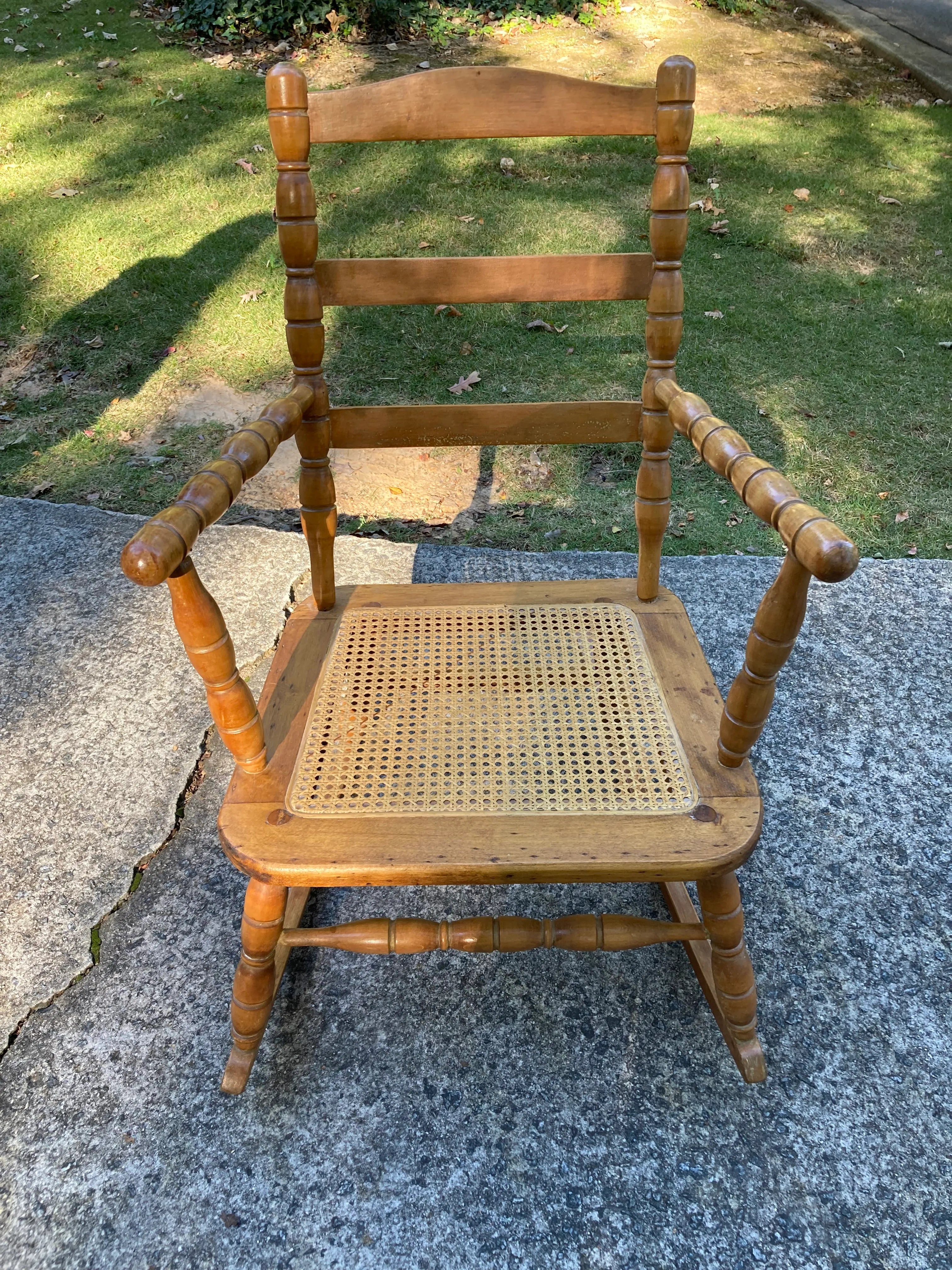 Late 19th Century Antique Turned Wood Ladder Back Open Arm Rocking Chair With Caned Seat