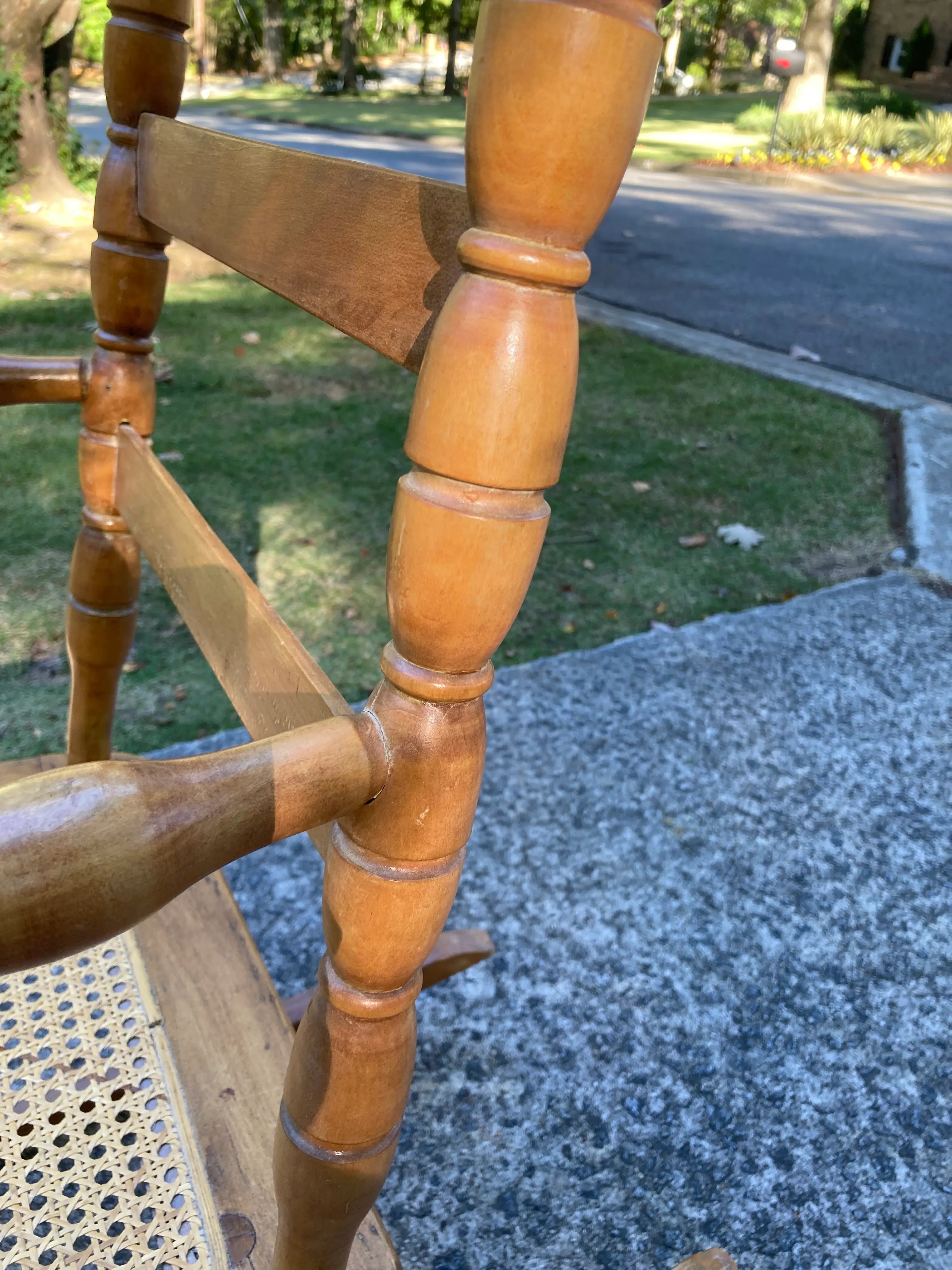 Late 19th Century Antique Turned Wood Ladder Back Open Arm Rocking Chair With Caned Seat