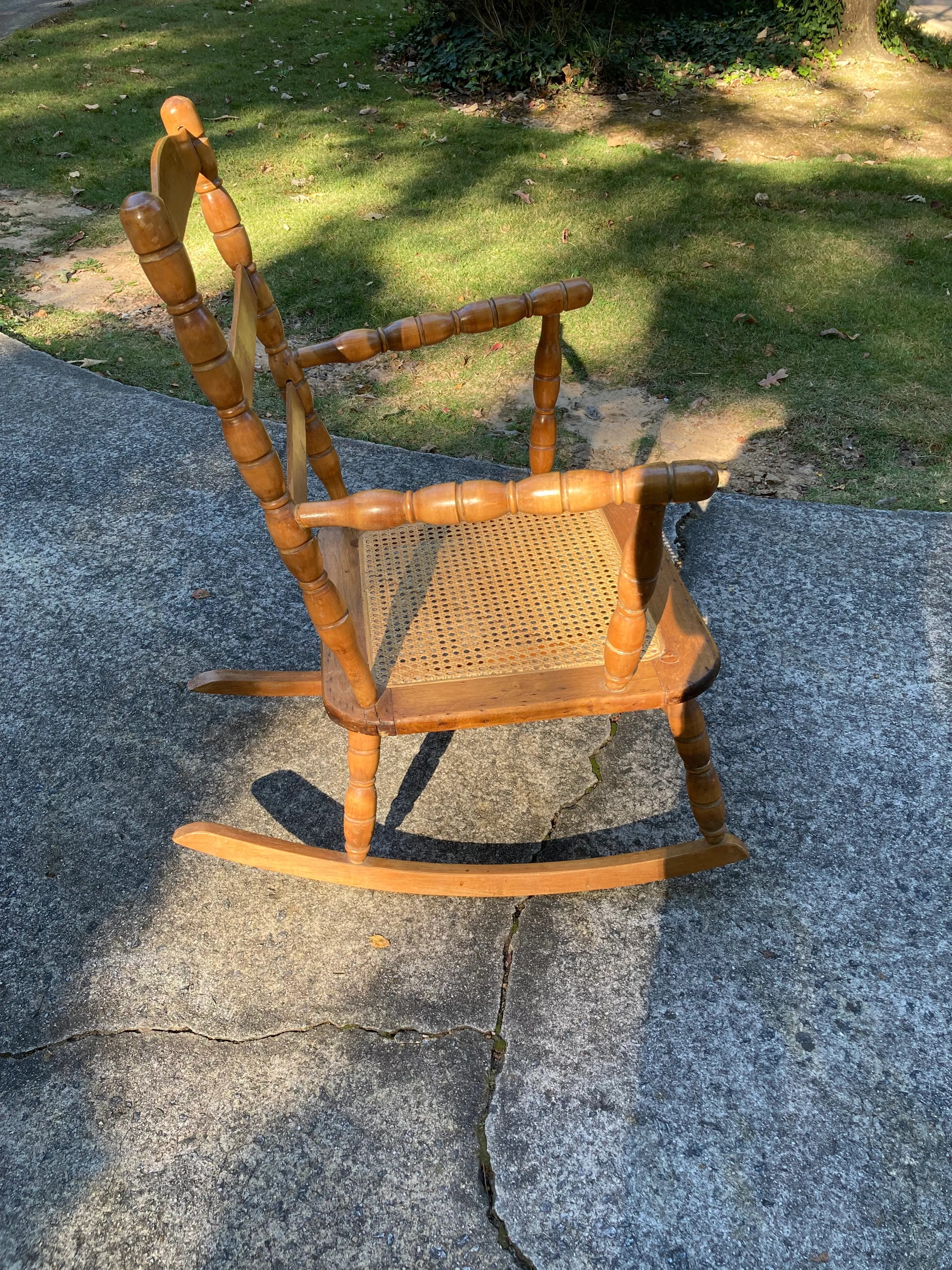 Late 19th Century Antique Turned Wood Ladder Back Open Arm Rocking Chair With Caned Seat
